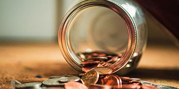change coming out of a mason jar that is sideways on a table